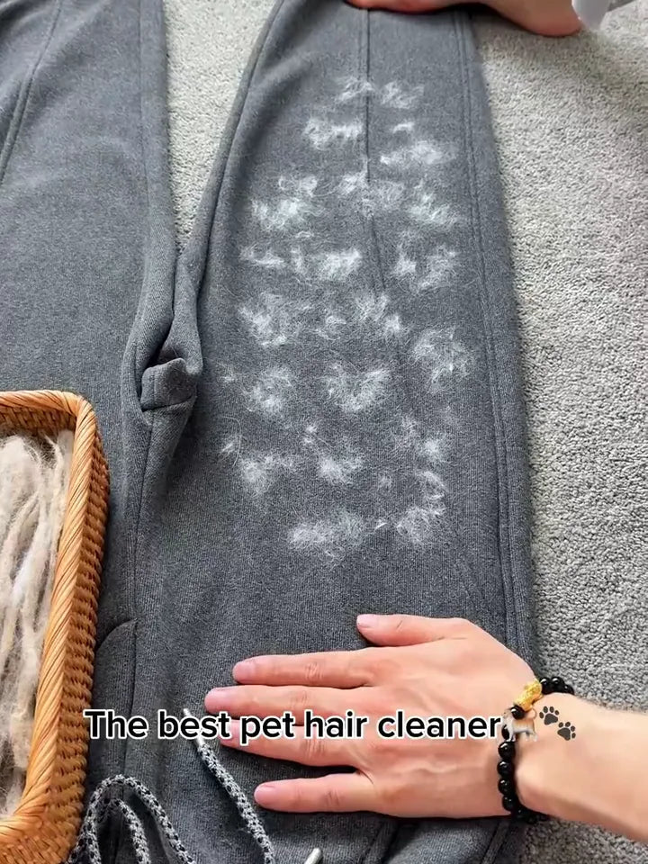 FurSweep Mitt removing pet hair from grey trousers.