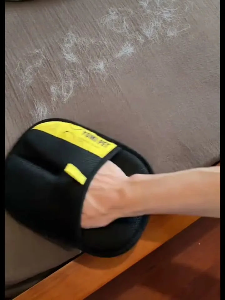 FurSweep Mitt gathering pet hair from dark fabric.