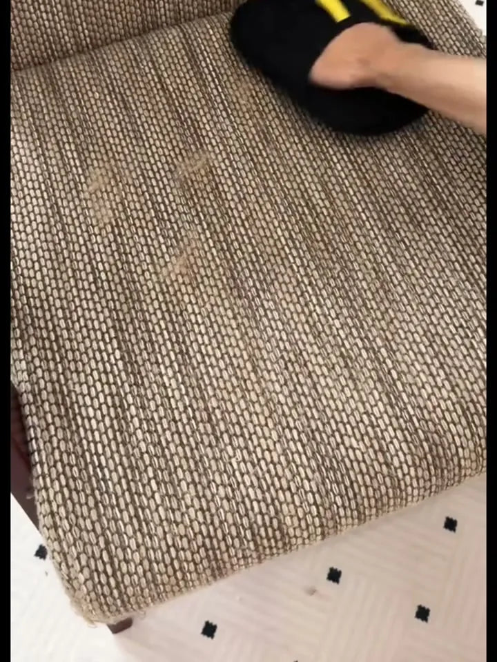 FurSweep Mitt swiping pet hair from upholstery.